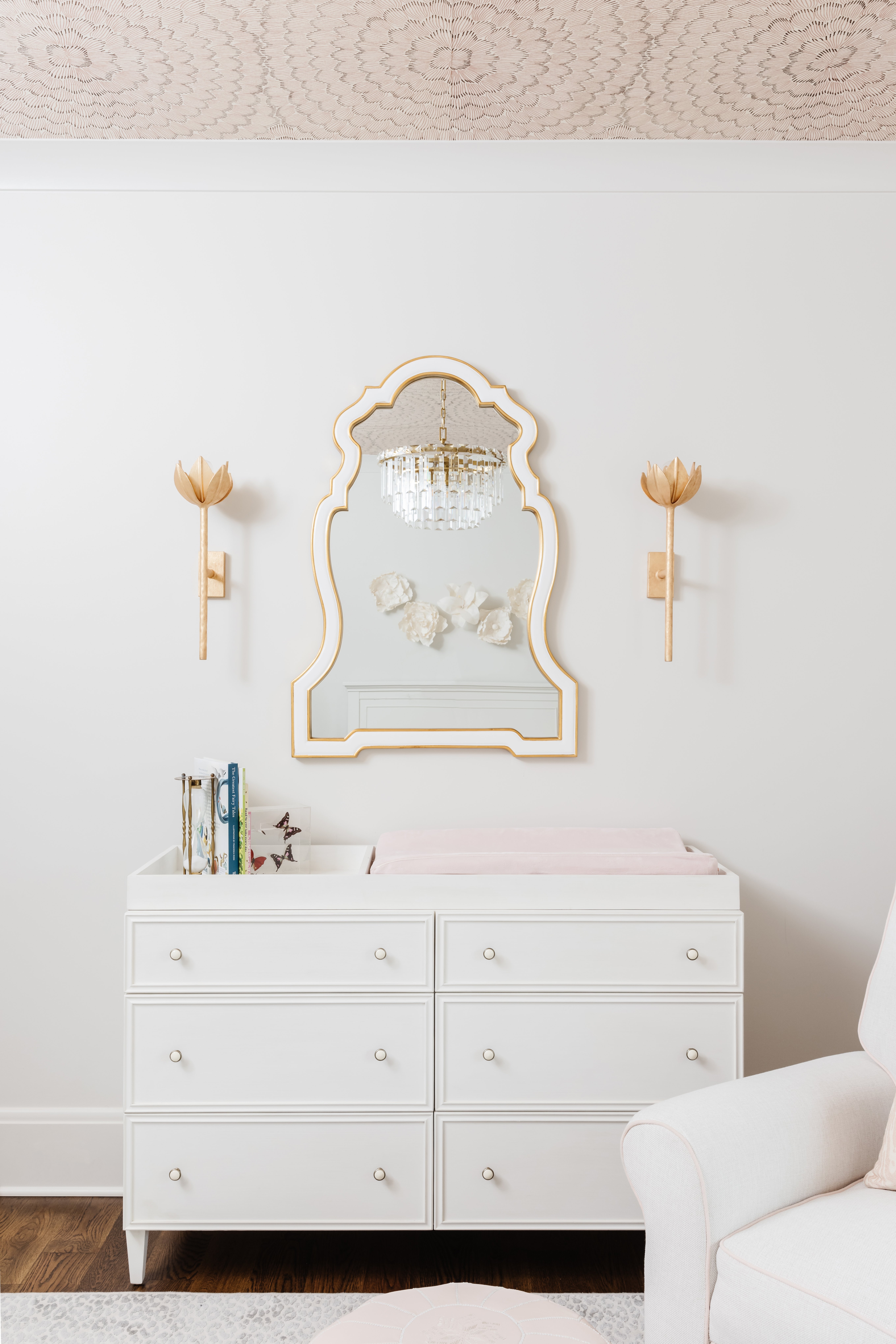 changing table with sconces in girls nursery