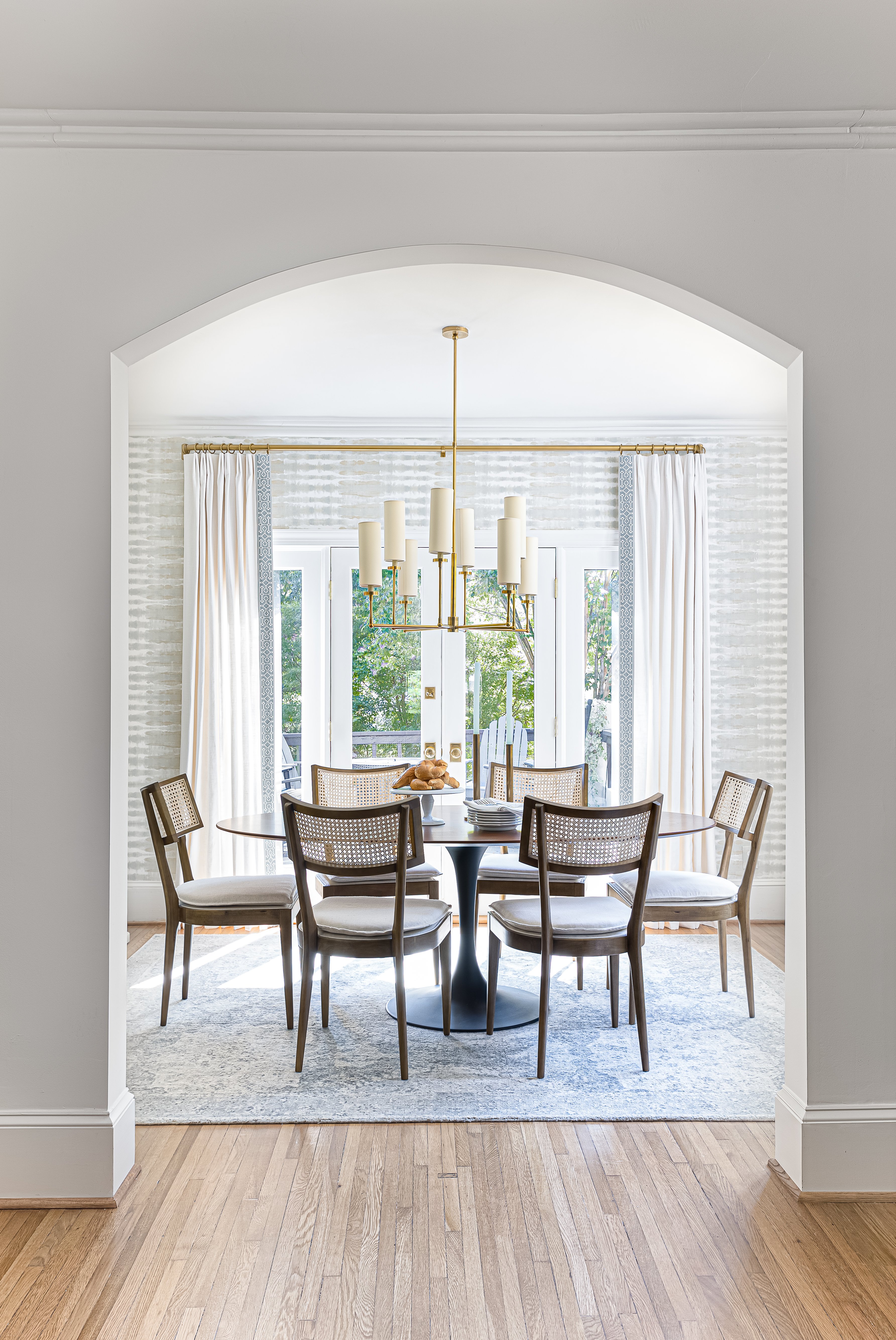 arched wall look into dining room